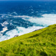 Summer landscape with vibrant green meadows by the ocean on Faroe Islands, Denmark. Summer landscape with vibrant green meadows by the ocean on Faroe Islands, Denmark. - PhotoDune Item for Sale