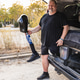Man holding prosthetic leg sitting by van Man holding prosthetic leg sitting by van - PhotoDune Item for Sale