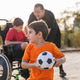 Children playing soccer, including boy with wheelchair and prosthesis Children playing soccer, including boy with wheelchair and prosthesis - PhotoDune Item for Sale