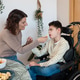 Mother spoon feeding son with cerebral palsy Mother spoon feeding son with cerebral palsy - PhotoDune Item for Sale
