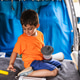 Boy playing with camping equipment in camper van Boy playing with camping equipment in camper van - PhotoDune Item for Sale