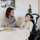 Mother playing sensory activities with son in wheelchair Mother playing sensory activities with son in wheelchair - PhotoDune Item for Sale