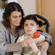 Mother providing sensory activity to child with cerebral palsy Mother providing sensory activity to child with cerebral palsy - PhotoDune Item for Sale
