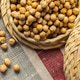 Yellow chickpeas are placed in woven baskets on a textured fabric background Yellow chickpeas are placed in woven baskets on a textured fabric background - PhotoDune Item for Sale