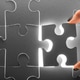 Puzzle piece being placed in an incomplete puzzle with light shining through Puzzle piece being placed in an incomplete puzzle with light shining through - PhotoDune Item for Sale
