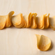 Stacked potato chips on wooden surface ready for snacking and sharing with friends Stacked potato chips on wooden surface ready for snacking and sharing with friends - PhotoDune Item for Sale