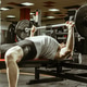 Weightlifting session in a gym with a man lifting a barbell on a bench Weightlifting session in a gym with a man lifting a barbell on a bench - PhotoDune Item for Sale