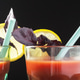 Two glasses of red drink with lemon slices and purple leaves against a black background Two glasses of red drink with lemon slices and purple leaves against a black background - PhotoDune Item for Sale