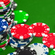 Colorful poker chips stack on green table with scattered chips during game night Colorful poker chips stack on green table with scattered chips during game night - PhotoDune Item for Sale