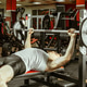 Man works out in gym while lifting weights on bench press in morning session Man works out in gym while lifting weights on bench press in morning session - PhotoDune Item for Sale