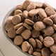 Dog food bowl filled with round pieces of dry kibble Dog food bowl filled with round pieces of dry kibble - PhotoDune Item for Sale