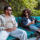 Diverse men enjoying drinks and conversation on an outdoor patio Diverse men enjoying drinks and conversation on an outdoor patio - PhotoDune Item for Sale