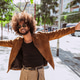 Smiling man with afro hair expressing freedom on city street Smiling man with afro hair expressing freedom on city street - PhotoDune Item for Sale