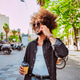 Smiling man talking on phone with coffee in city Smiling man talking on phone with coffee in city - PhotoDune Item for Sale