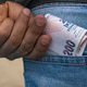 Putting Turkish lira banknotes into blue jeans pocket Putting Turkish lira banknotes into blue jeans pocket - PhotoDune Item for Sale