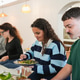 Multiracial people eating lunch inside modern restaurant Multiracial people eating lunch inside modern restaurant - PhotoDune Item for Sale
