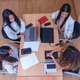 Four women busy working and collaborating at an office desk, discussing, using laptops and tablets f Four women busy working and collaborating at an office desk, discussing, using laptops and tablets f - PhotoDune Item for Sale