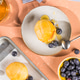 Scone Filled with Blueberry and Clotted Cream on a plate Scone Filled with Blueberry and Clotted Cream on a plate - PhotoDune Item for Sale