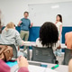 Professor teaching math class discussing equation with students Professor teaching math class discussing equation with students - PhotoDune Item for Sale