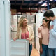 Saleswoman assisting couple choosing new refrigerator at appliance store Saleswoman assisting couple choosing new refrigerator at appliance store - PhotoDune Item for Sale