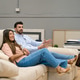 Couple sitting on sofa in furniture store choosing home decor Couple sitting on sofa in furniture store choosing home decor - PhotoDune Item for Sale
