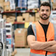 Male warehouse worker smiling in distribution center Male warehouse worker smiling in distribution center - PhotoDune Item for Sale