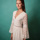 Young woman wearing a white lace bohemian dress Young woman wearing a white lace bohemian dress - PhotoDune Item for Sale
