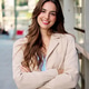 Young woman smiling with arms crossed urban setting Young woman smiling with arms crossed urban setting - PhotoDune Item for Sale