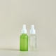 Green And Frosted Dropper Bottles Standing Side By Side On Neutral Beige Surface In Minimalist Green And Frosted Dropper Bottles Standing Side By Side On Neutral Beige Surface In Minimalist - PhotoDune Item for Sale