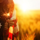 Young woman with American flag in a wheat field at sunset. 4th of July. Patriotic holiday. Young woman with American flag in a wheat field at sunset. 4th of July. Patriotic holiday. - PhotoDune Item for Sale