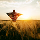 Young Woman with the American flag running in a wheat field at sunset. 4th of July. Young Woman with the American flag running in a wheat field at sunset. 4th of July. - PhotoDune Item for Sale