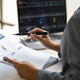Businesswoman working with documents is analyzing financial data statistically, calculating income a Businesswoman working with documents is analyzing financial data statistically, calculating income a - PhotoDune Item for Sale