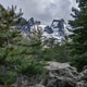 Mountains and trees near a rocky area with snow on the peaks in the background. Corsica, France. Mountains and trees near a rocky area with snow on the peaks in the background. Corsica, France. - PhotoDune Item for Sale