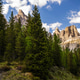 Mountains and trees surround a valley during a sunny day in nature Mountains and trees surround a valley during a sunny day in nature - PhotoDune Item for Sale