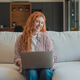 Young redhead woman smiling, working from home on laptop Young redhead woman smiling, working from home on laptop - PhotoDune Item for Sale