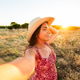 Young woman enjoying sunset in golden hour field Young woman enjoying sunset in golden hour field - PhotoDune Item for Sale