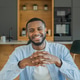 Happy young black man smiling in modern kitchen Happy young black man smiling in modern kitchen - PhotoDune Item for Sale