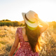 Woman enjoying golden hour sunset in an expansive field Woman enjoying golden hour sunset in an expansive field - PhotoDune Item for Sale