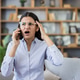 Stressed young woman having frustrating phone call at home Stressed young woman having frustrating phone call at home - PhotoDune Item for Sale