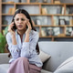 Stressed woman experiencing headache while talking on smartphone Stressed woman experiencing headache while talking on smartphone - PhotoDune Item for Sale