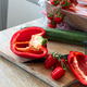 Chopping bell pepper and tomatoes on wooden board Chopping bell pepper and tomatoes on wooden board - PhotoDune Item for Sale