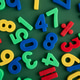 Colorful plastic numbers and mathematical symbols on green background Colorful plastic numbers and mathematical symbols on green background - PhotoDune Item for Sale