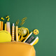 Yellow school supplies spilling from pencil case on green background Yellow school supplies spilling from pencil case on green background - PhotoDune Item for Sale