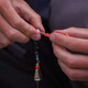 A fisherman puts on a silicone bait, close-up A fisherman puts on a silicone bait, close-up - PhotoDune Item for Sale