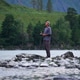 A Fishing Enthusiast in a Mountain River A Fishing Enthusiast in a Mountain River - PhotoDune Item for Sale