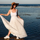 Woman in sun hat and white flowing skirt standing on shore at seaside vacation during summer Woman in sun hat and white flowing skirt standing on shore at seaside vacation during summer - PhotoDune Item for Sale