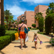 Father and daughter walking through resort gardens on summer family vacation toward pool Father and daughter walking through resort gardens on summer family vacation toward pool - PhotoDune Item for Sale