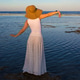 Woman in sun hat and white skirt standing on shore at seaside vacation during summer Woman in sun hat and white skirt standing on shore at seaside vacation during summer - PhotoDune Item for Sale