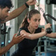 Female athlete receiving exercise guidance from a personal trainer while using a cable machine at th Female athlete receiving exercise guidance from a personal trainer while using a cable machine at th - PhotoDune Item for Sale