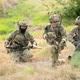 Military team pauses to assess surroundings and coordinate movement Military team pauses to assess surroundings and coordinate movement - PhotoDune Item for Sale